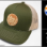 Buff Daddy Coin-Patch Baseball Cap.<br/><br/>Colors: Navy, Caramel.<br/>This cap features a laser-etched, faux-suede leather patch.<br/>Pacific Headwear® #104S, Trucker Snapback design. Adjustable.<br/><br/>